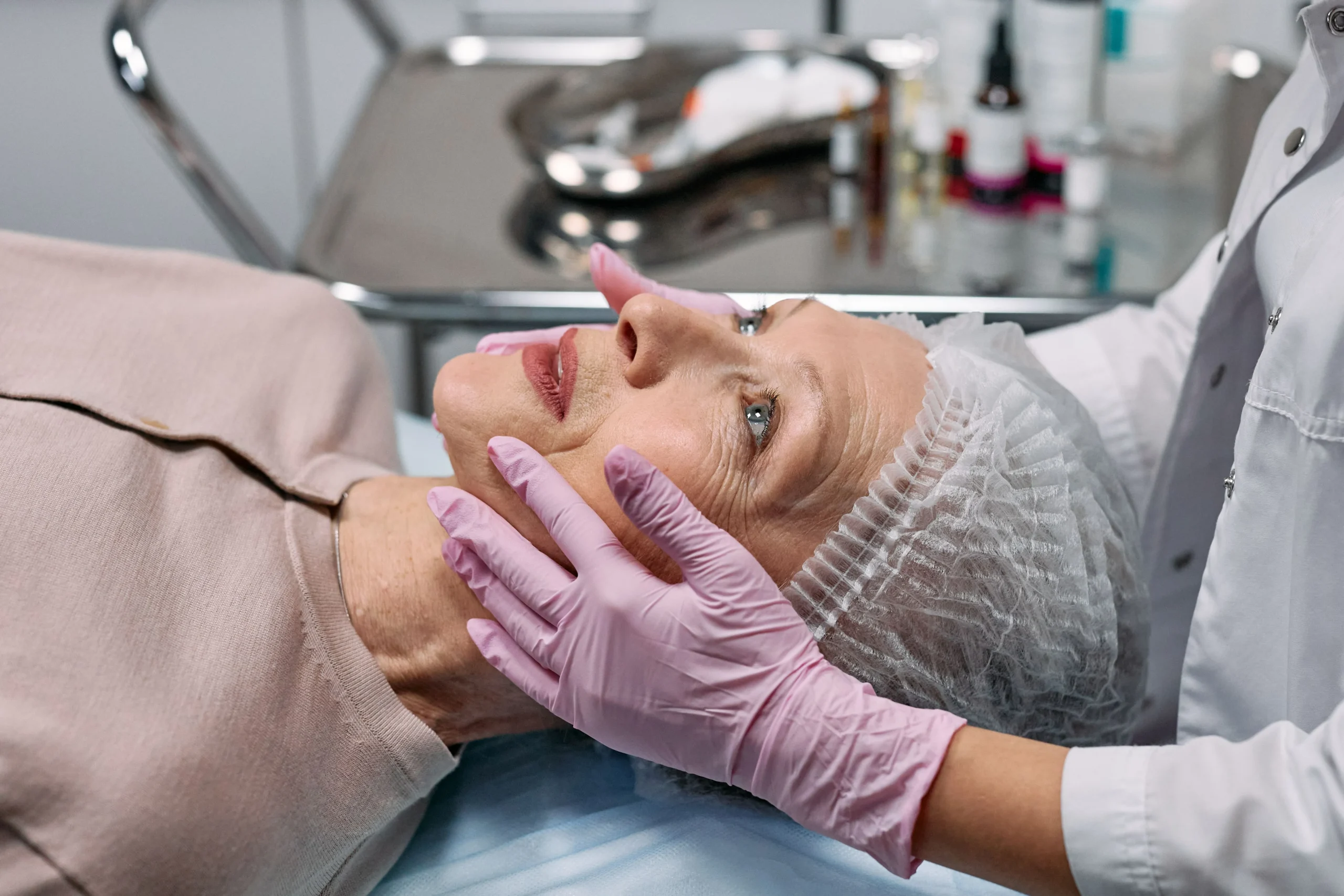 Practitioner assessing facial balance before facelift surgery.