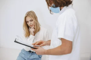 Patient reviewing treatment information with a clinician during a consultation.
